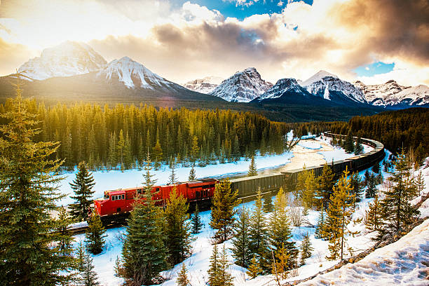 A luxury train moving through the Canadian Rockies mountains